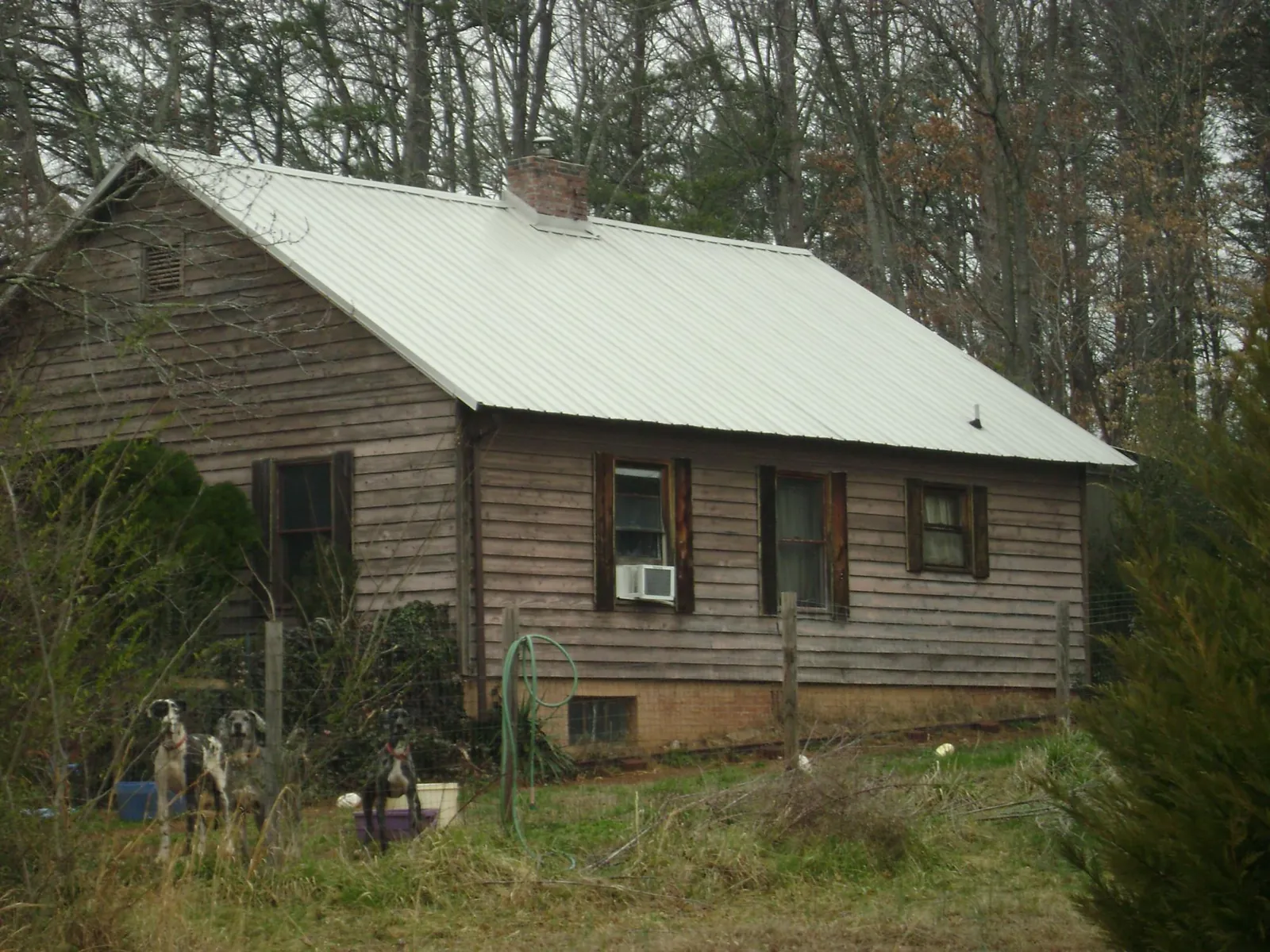 White metal roof on an old wood sided farmhouse, from a Metal Roof Installation job in Middle Island